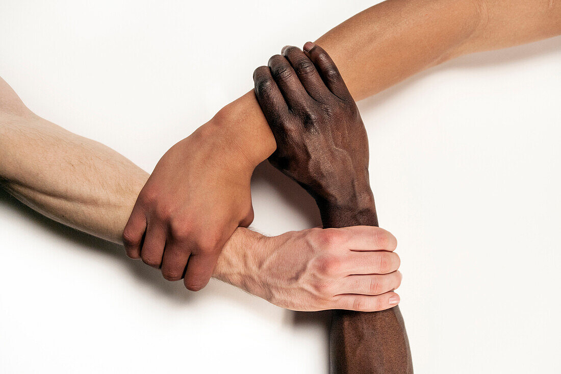 3 interlocking arms with white, half-cast and Afro-American skin