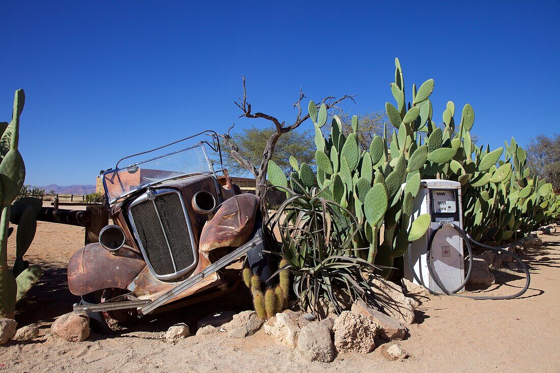 rusty old car and old gasoline pump in Solitaire, Namibia