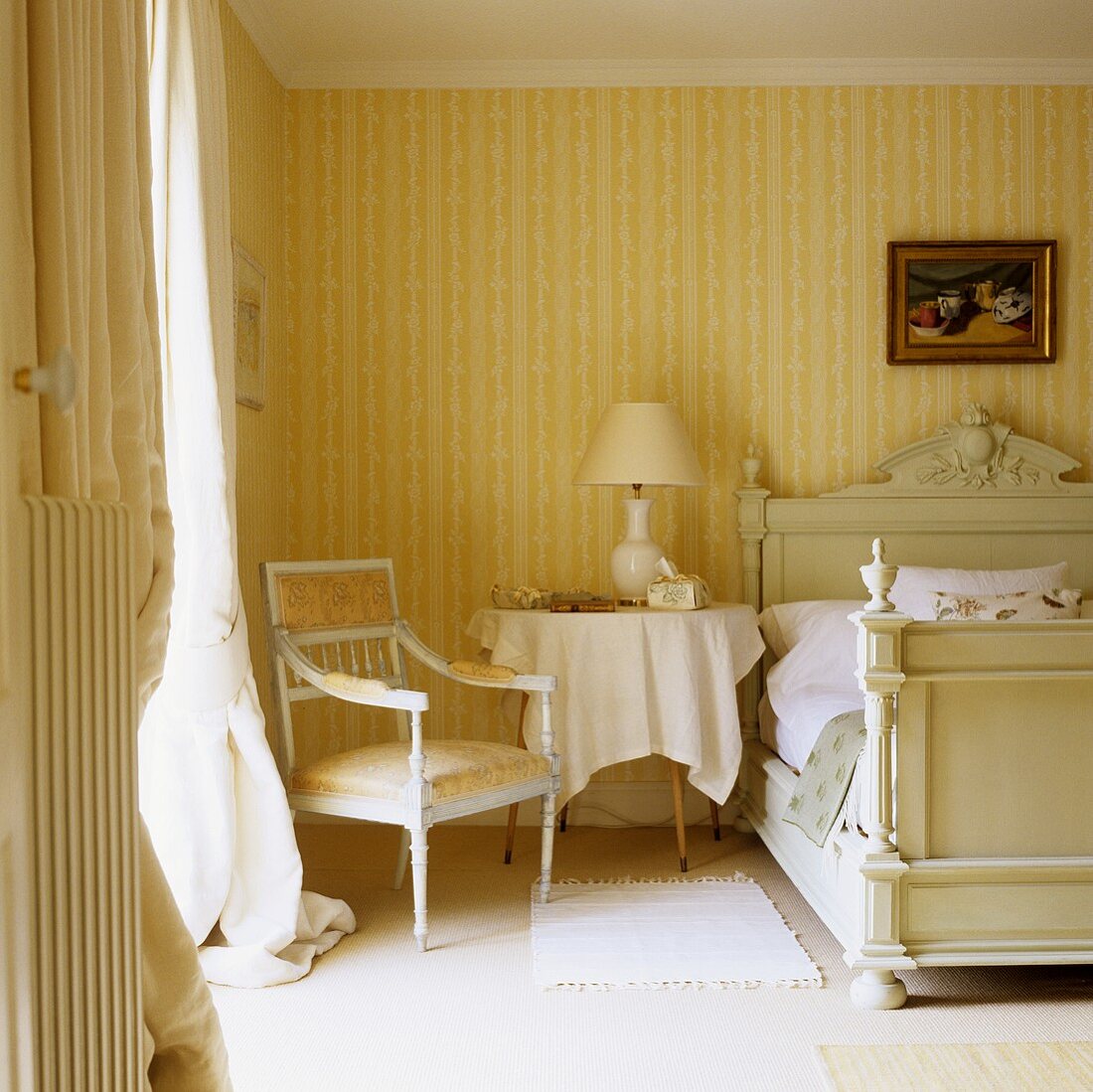 A bedroom in a country house with Baroque chairs against a yellow and white striped wall