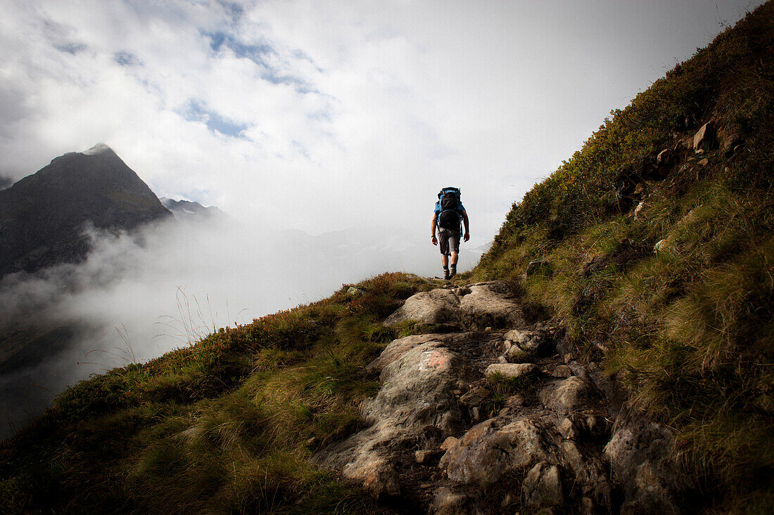 Man on a mountain trail, ascent to Bremer Hut (2413 m), rear of Gschnitz Valley, Stubai Alps, Tyrol, Austria