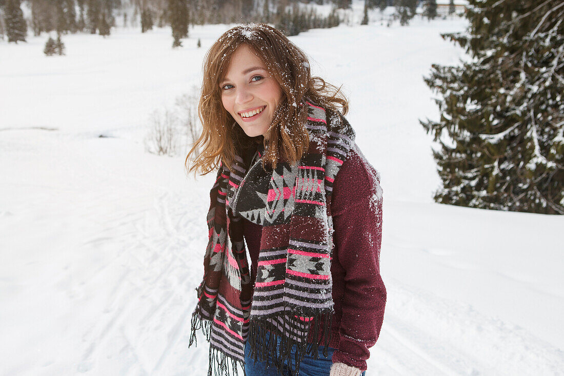 Young woman smiling at camera, Spitzingsee, Upper Bavaria, Germany