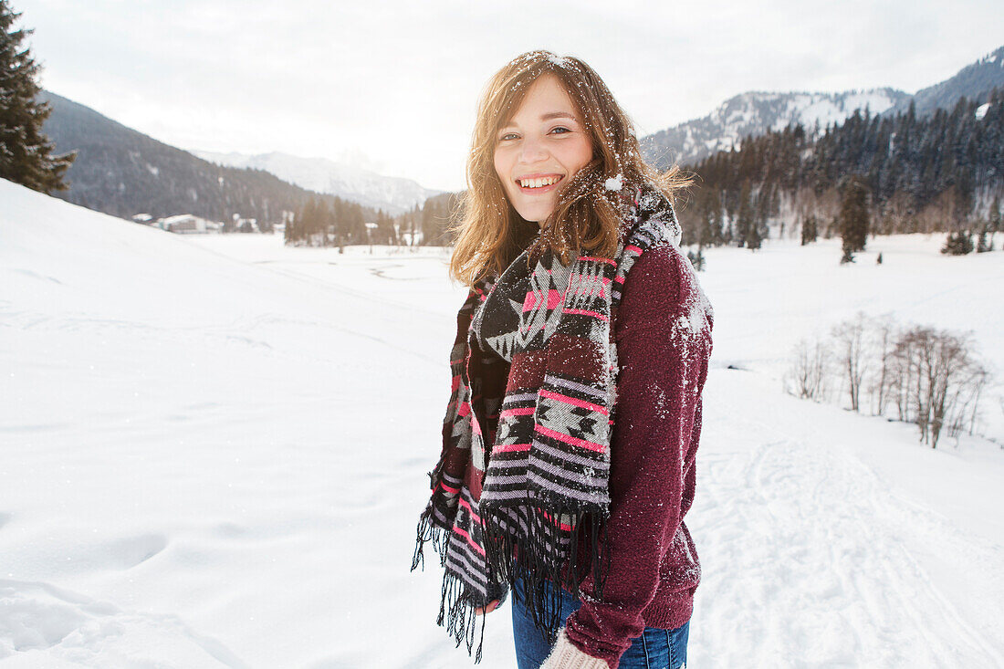 Young woman smiling at camera, Spitzingsee, Upper Bavaria, Germany