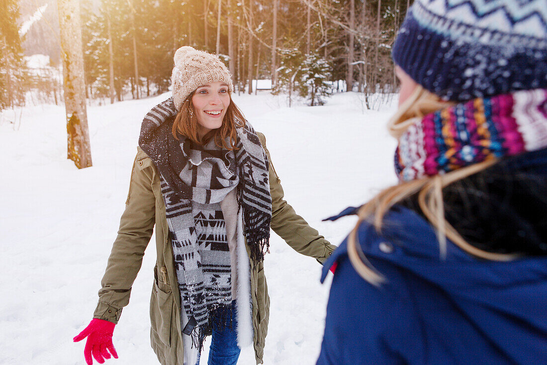 Two young women in snow, Spitzingsee, Upper Bavaria, Germany