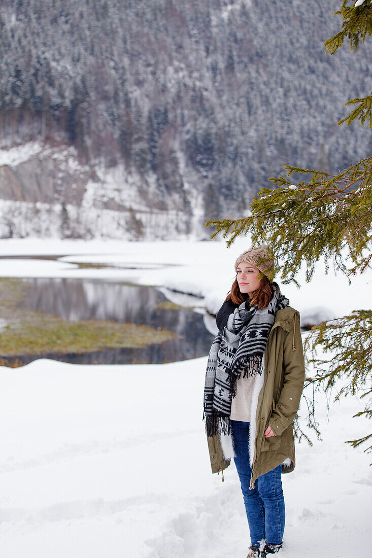 Young woman in snow, Spitzingsee, Upper Bavaria, Germany