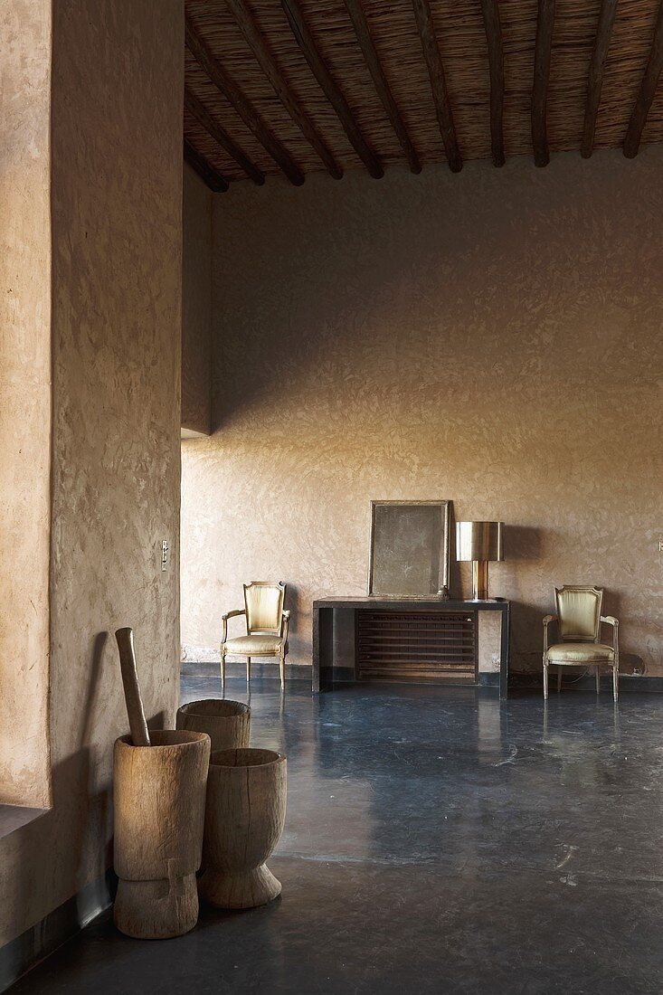 A minimalistic anteroom with wooden tubs in a Mediterranean country house