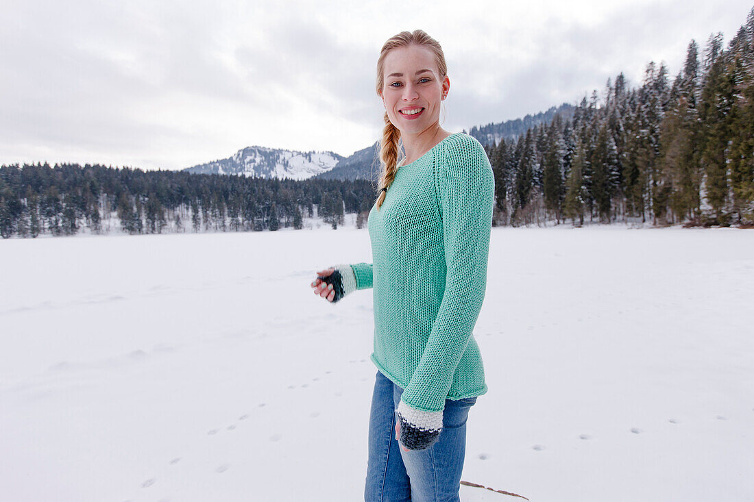 Young woman in snow, Spitzingsee, Upper Bavaria, Germany