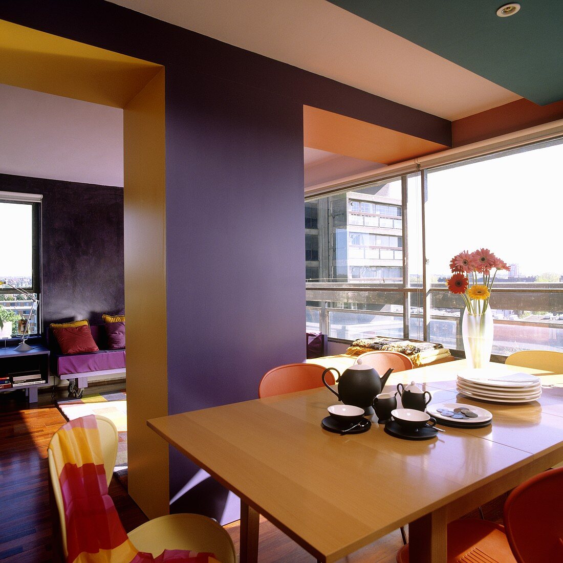 A colourful room - coffee break in an open-plan living room-cum-dining room with a glass wall