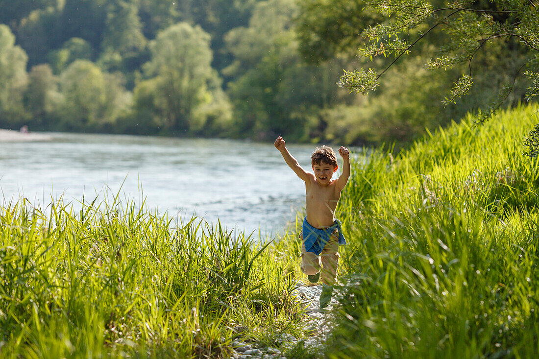 Boy running along the river banks of the Isar, Isar valley, Pullach im Isartal, south of Munich, Upper Bavaria, Bavaria, Germany, Europe