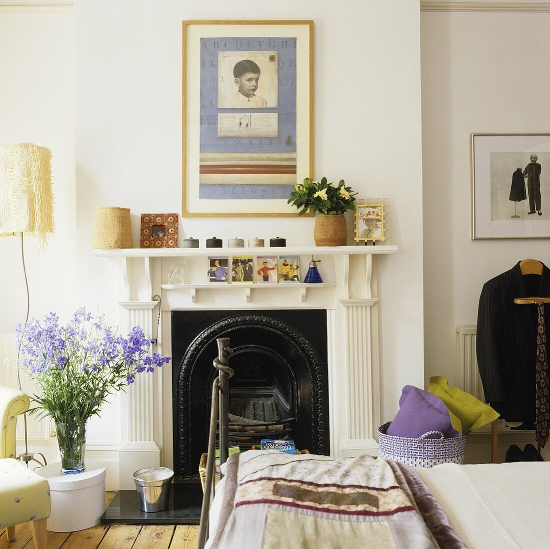 A fireplace with a white mantelpiece in a bedroom