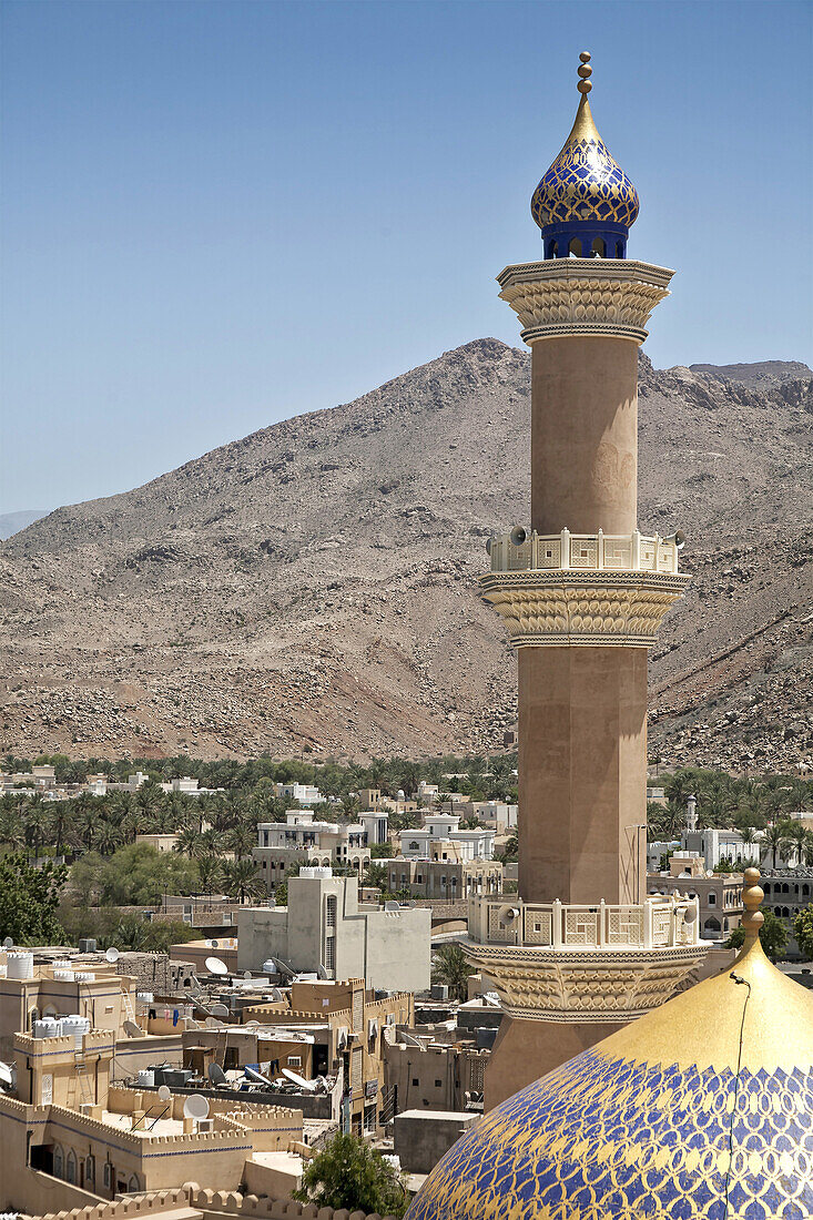 View from Nizwa Fort of the minaret of the As Sultan Qaboos Mosque with the Hajar Mountains in the background, Al Jinah, Nizwa, Ad Dakhiliyah Governorate, Oman.