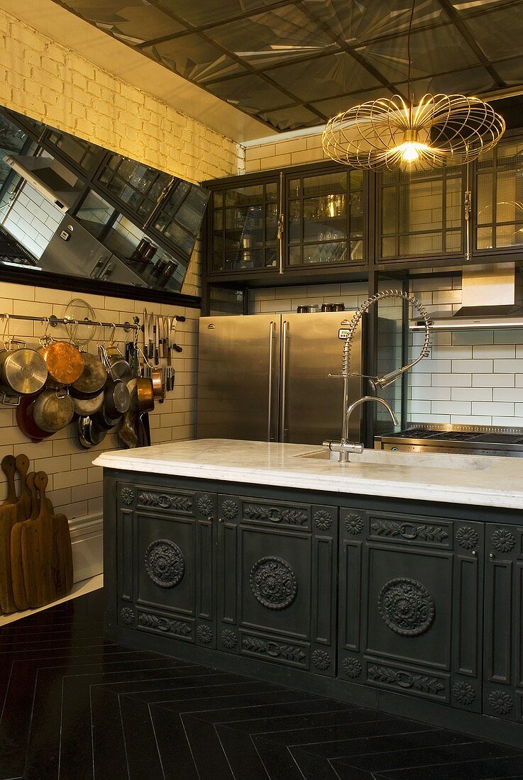 A traditional open-plan kitchen and a kitchen counter with artificial lighting