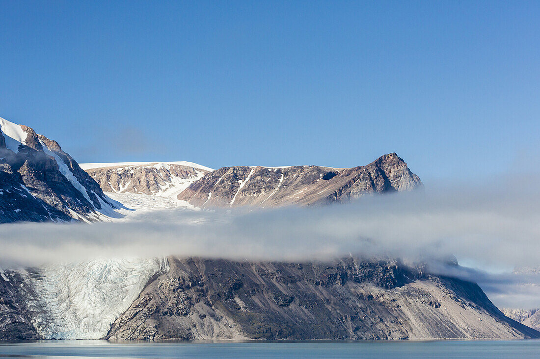 Fog lifting on the steep cliffs of Icy Arm, Baffin Island, Nunavut, Canada.