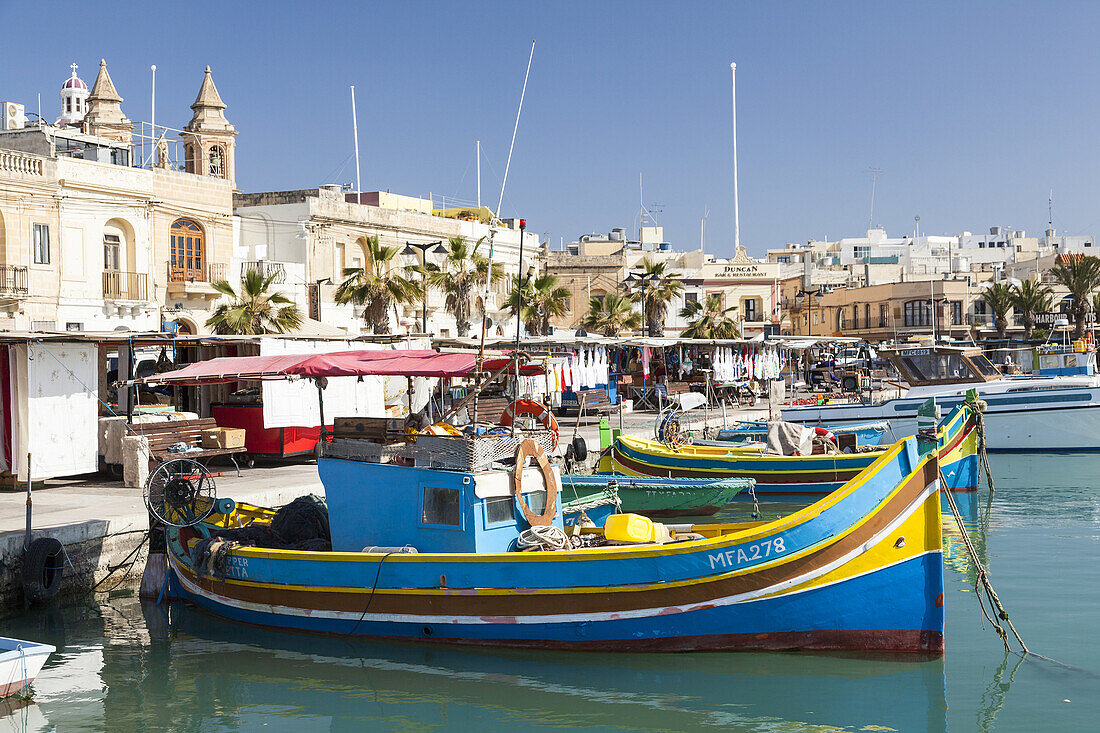 Fishing boats on the harbour of Marsaxlokk The colorfull traditional fishing boats are called Luzzu and have a painted eye on the bow, called eye of Horus or Osiris Europe, Southern Europe, Malta, April.