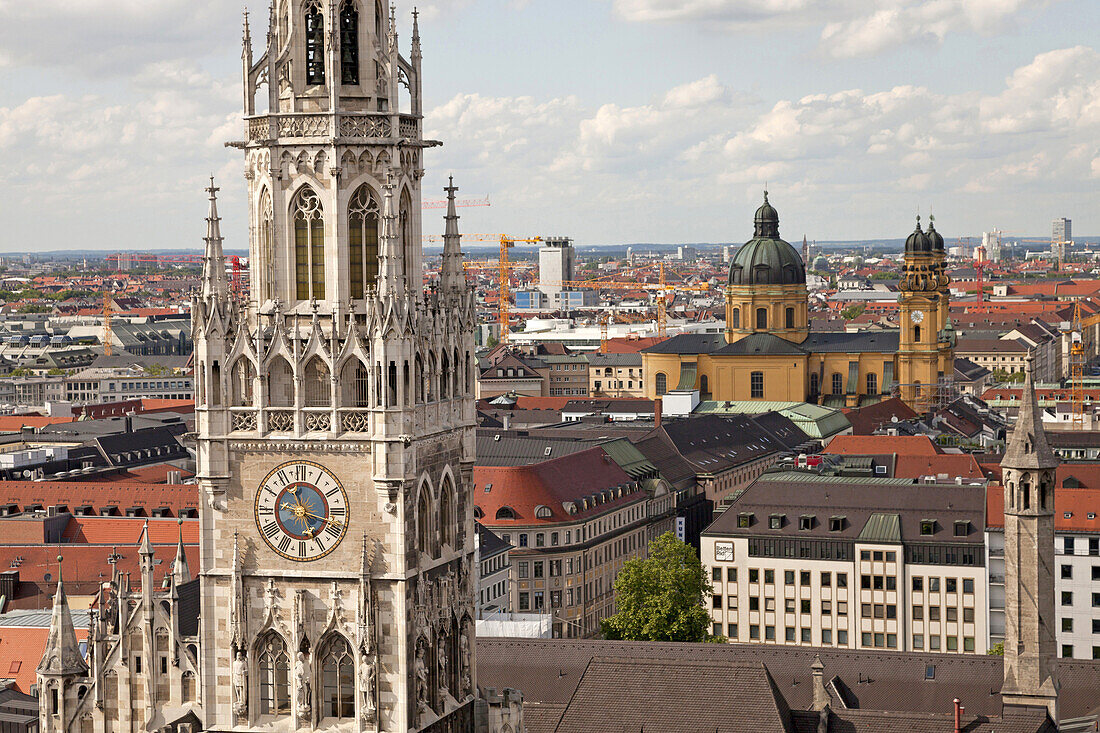  tower of the new townhall on the central square Marienplatz and the Theatine Church in Munich, Bavaria, Germany.