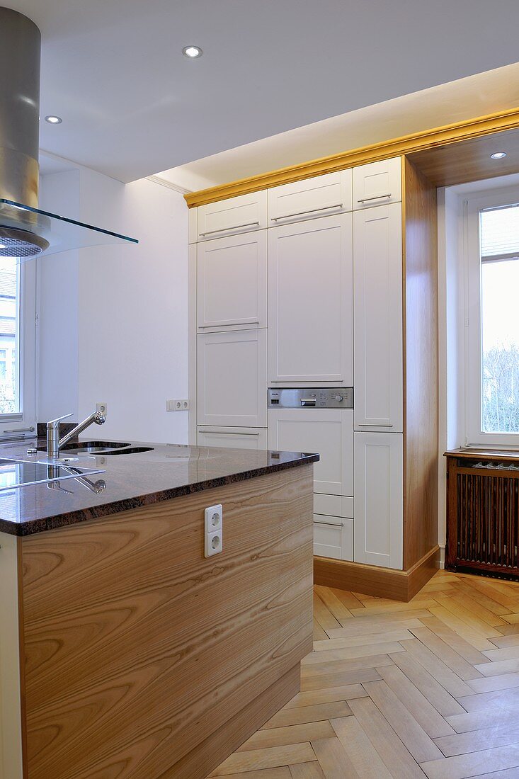 Extractor fan above central island unit in contemporary kitchen