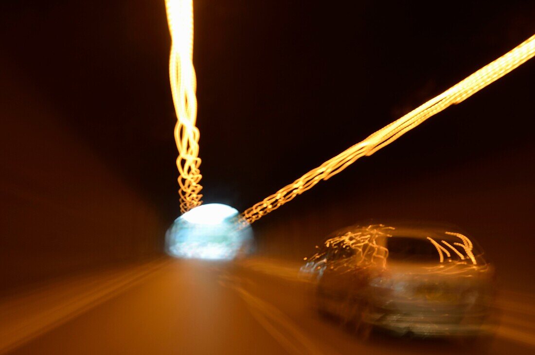 Speeding car inside a highway tunnel, France, blurred motion
