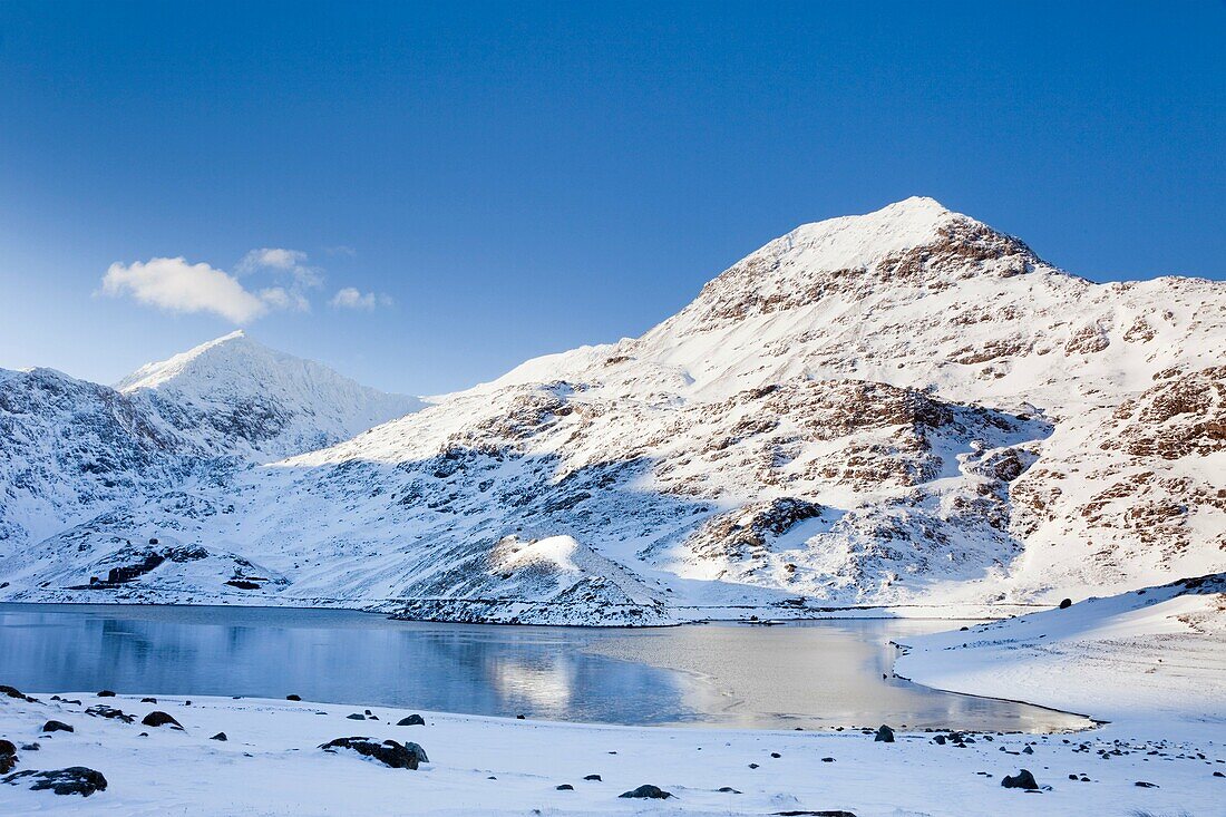 Pen-y-Pass, Gwynedd, North Wales, UK, Europe  View across Llyn Llydaw Cronfa Reservoir to Crib Goch and Mount Snowdon with snow in the mountains of Snowdonia National Park in winter