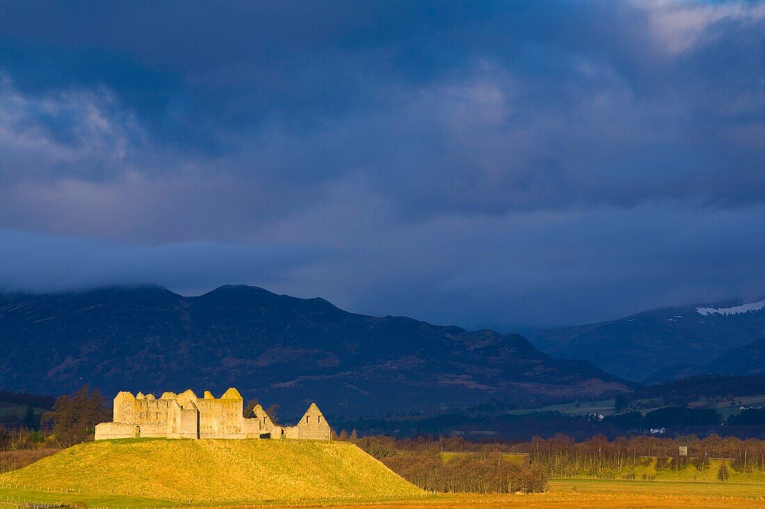 Scotland, Scottish Highlands, Cairngorms National Park  Dramatic light bathes the Ruthven Barracks, with the Monadhliath Mountains overlooking the ruins