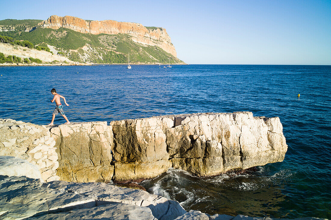 Boy on rocks, Cassis, bay of Cassis, Bouches-du-Rhone, France