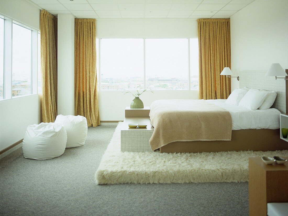 Double bed on raised platform in hotel bedroom