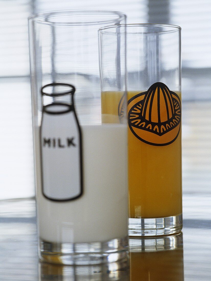 Glasses filled with milk and orange juice