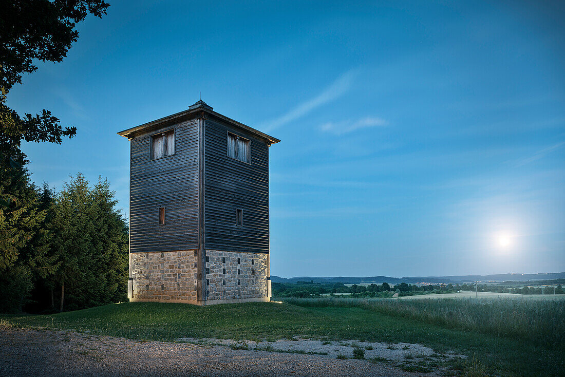 reconstruction of Roman watchtower during moonrise, Limes (border wall of Roman Empire) Park Rainau-Buch, Aalen, Ostalb province, Swabian Alb, Baden-Wuerttemberg, Germany, UNESCO world heritage site