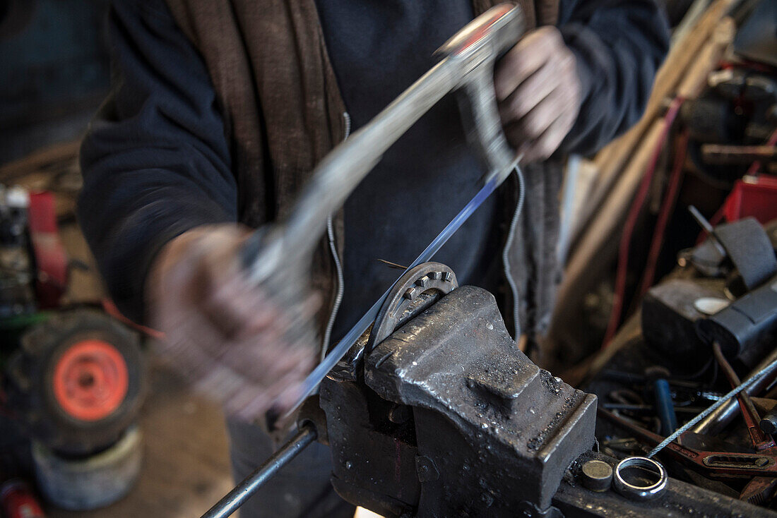Blacksmith working  on a horseshoe, Vellberg, Schwaebisch Hall, Baden-Wuerttemberg, Germany