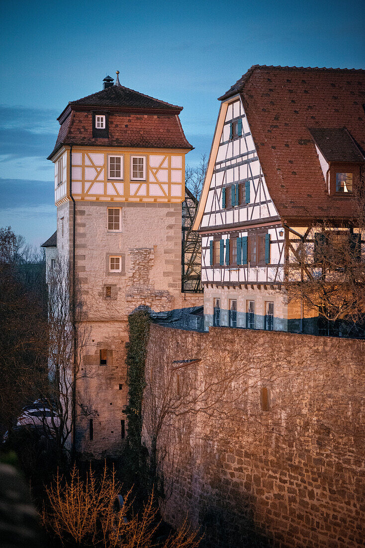 historic town wall and timber-frame house at dusk in Vellberg, Schwaebisch Hall, Baden-Wuerttemberg, Germany