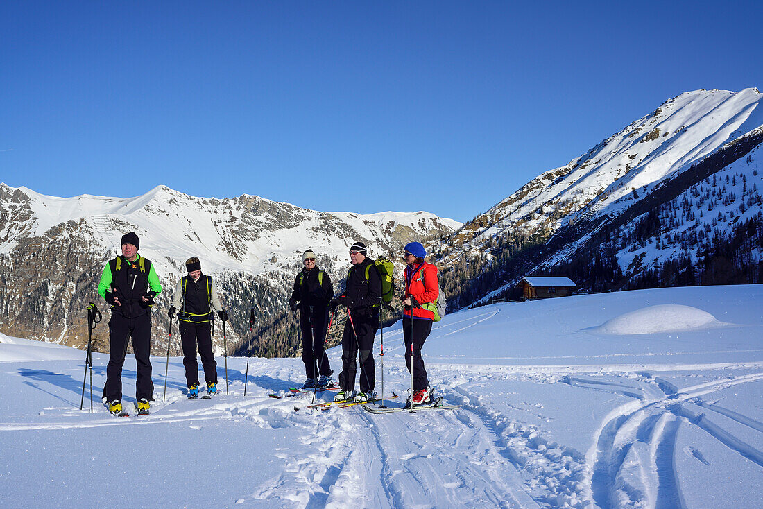 Several persons back-country skiing having a break, Kleiner Kaserer, valley of Schmirn, Zillertal Alps, Tyrol, Austria
