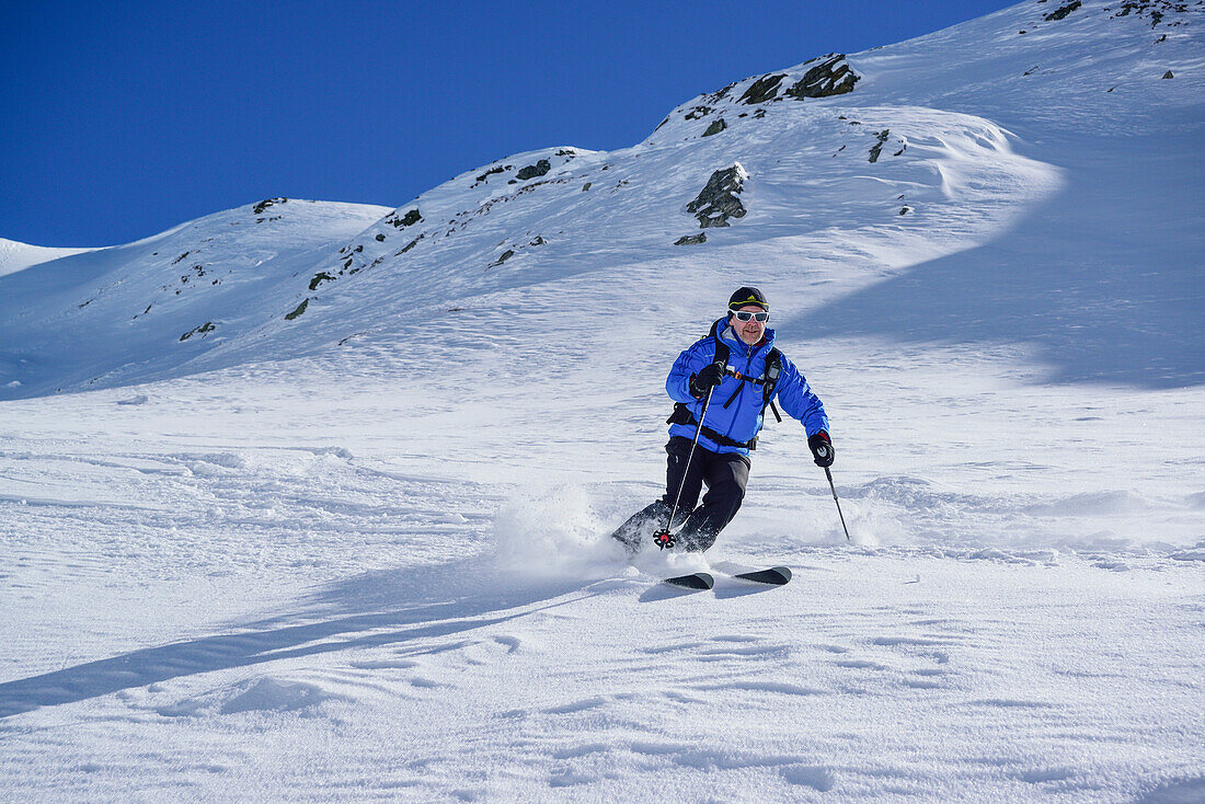Man back-country skiing downhill from Frauenwand, Frauenwand, valley of Schmirn, Zillertal Alps, Tyrol, Austria