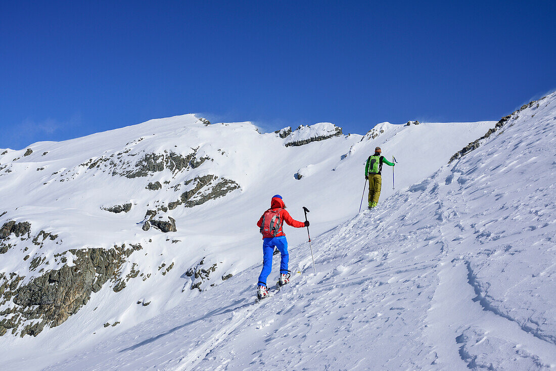 Two persons back-country skiing ascending towards Monte Faraut, Monte Faraut, Valle Varaita, Cottian Alps, Piedmont, Italy