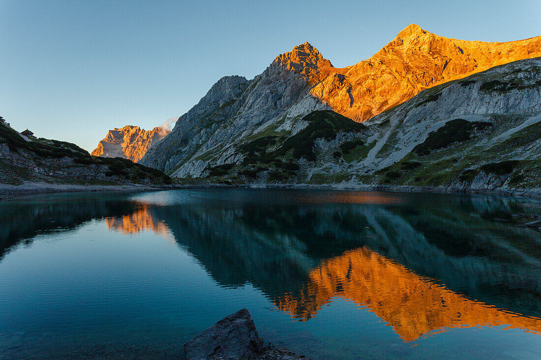 Lake Drachensee with mountain reflection, Mieminger mountains, Wetterstein mountains with Zugspitze at sunset, Coburger lodge, near Ehrwald, district Reutte, Tyrol, Austria, Europe
