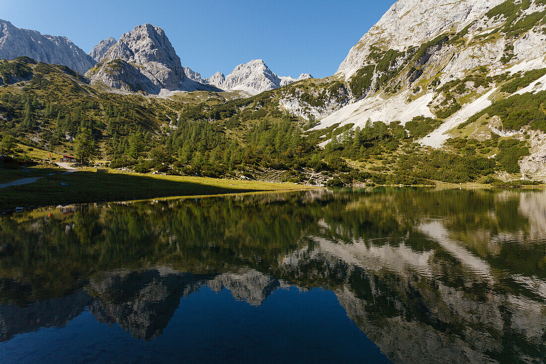 Lake Seebensee with reflection of the mountains, vorderer Drachenkopf (l.), near Ehrwald, district Reutte, Tyrol, Austria, Europe
