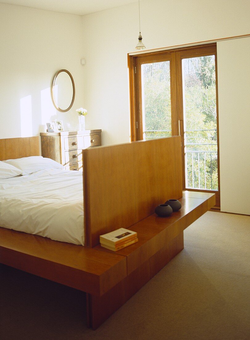 Double bed built into wooden platform