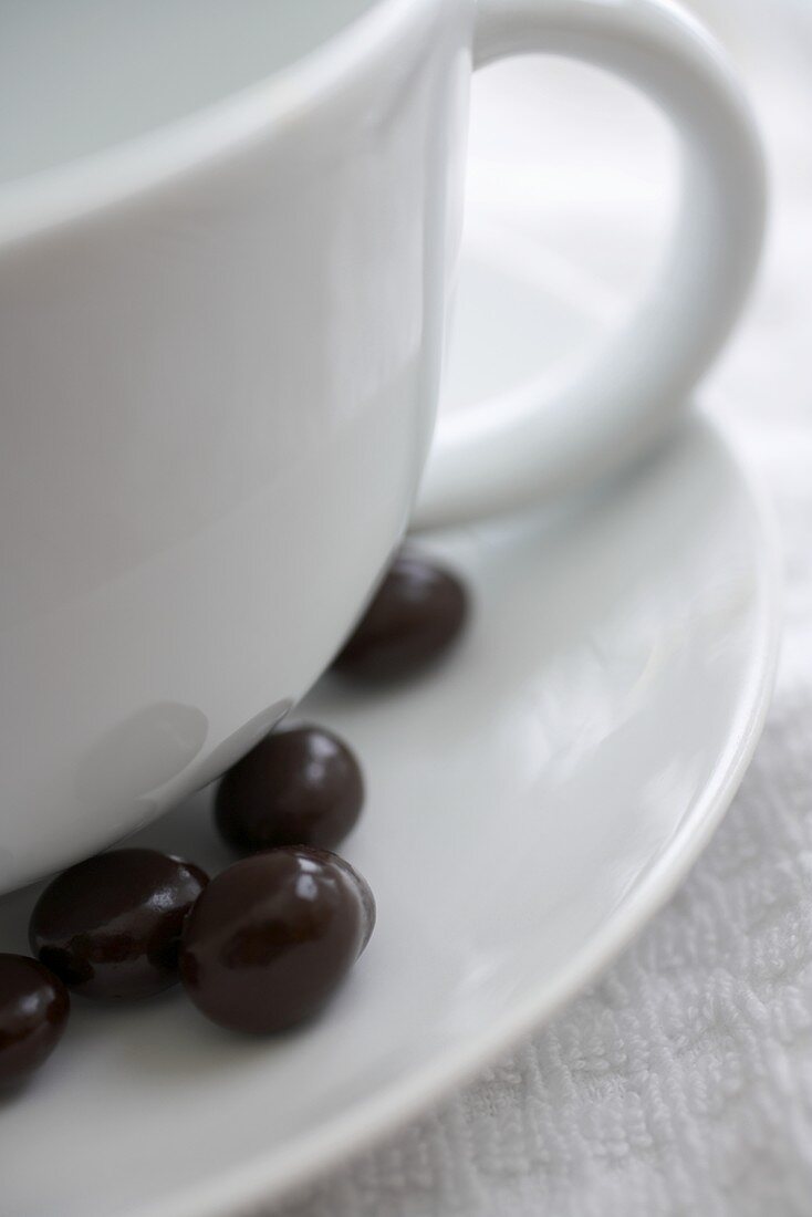 Chocolate Covered Espresso Beans on Saucer with Mug