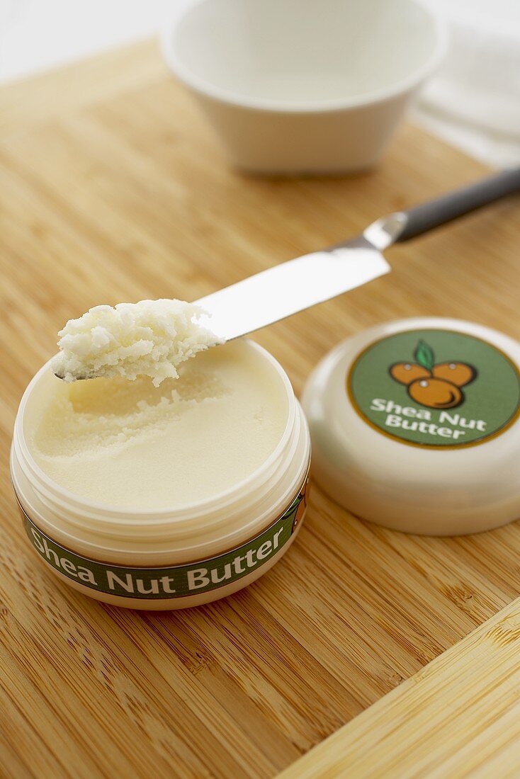 Opened Container of Shea Nut Butter with Knife