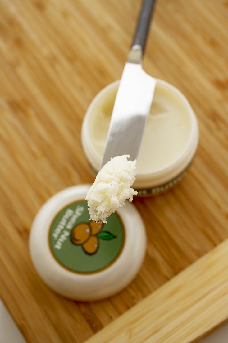 Knife with Shea Nut Butter on Shea Nut Butter Container