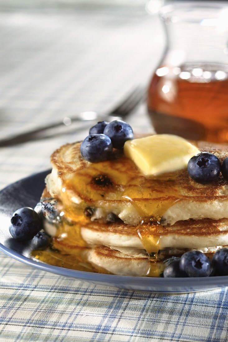Stack of Blueberry Pancakes with Butter and Maple Syrup