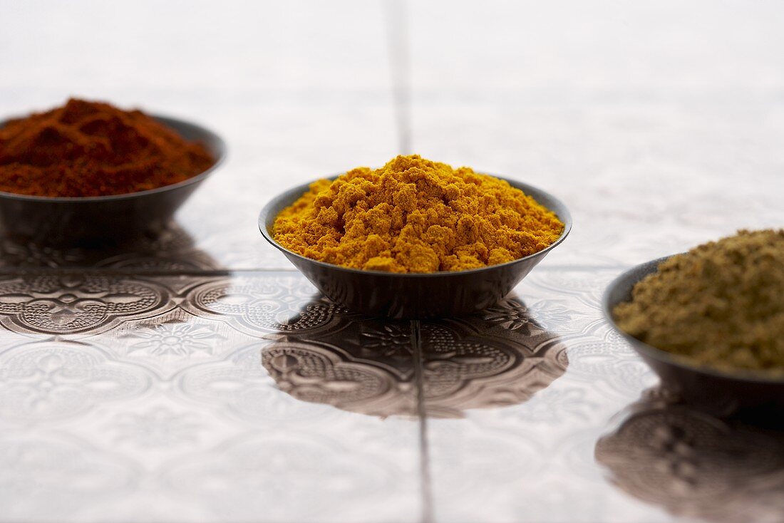Three Small Bowls of Assorted Ground Spices