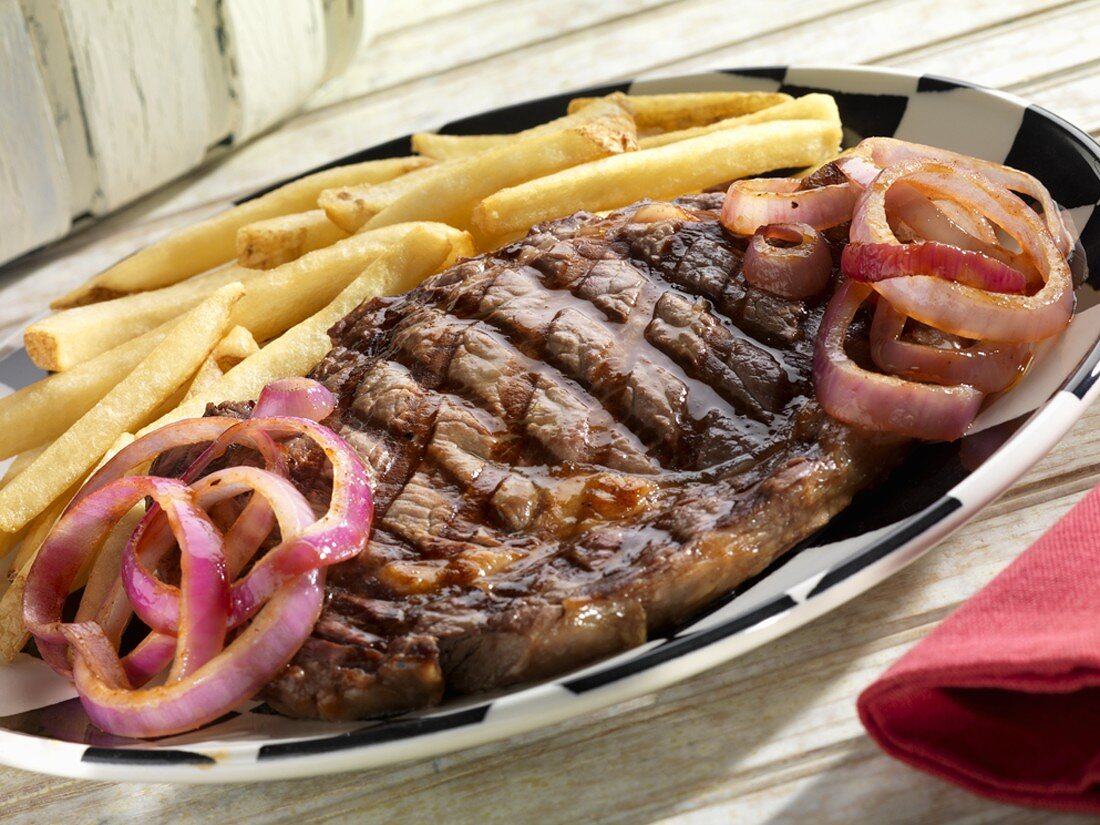 Boneless Rib Steak with Red Onions and French Fries