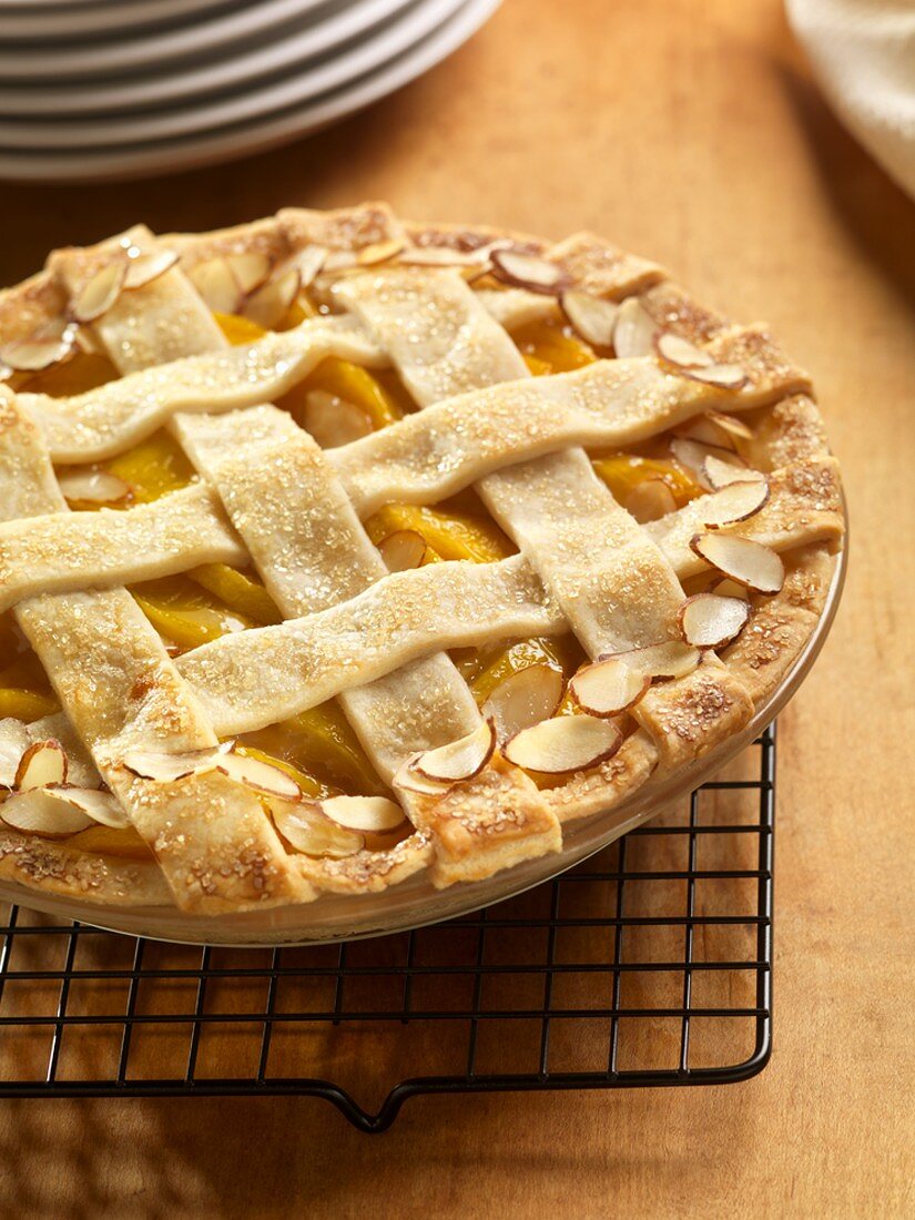 Peach Almond Pie with a Lattice Top on a Cooling Rack