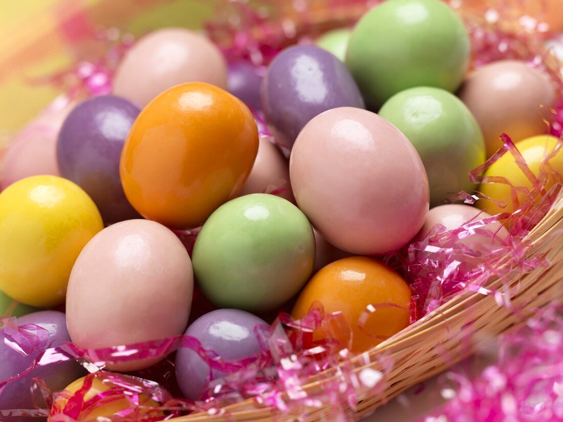 Candy Eggs in a Basket with Pink Grass, Close Up