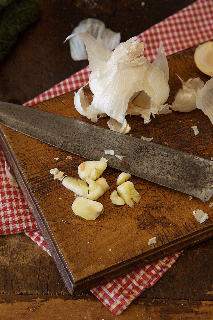 Garlic on a Cutting Board with a Knife