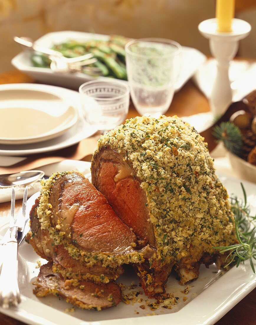 Herb Crusted Rib Roast Partially Sliced on a Platter