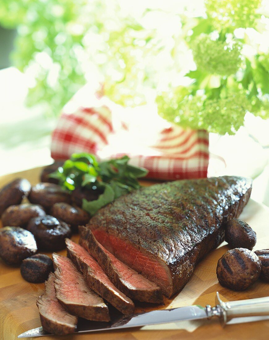 Partially Sliced Grilled London Broil with Grilled Mushrooms, Cutting Board