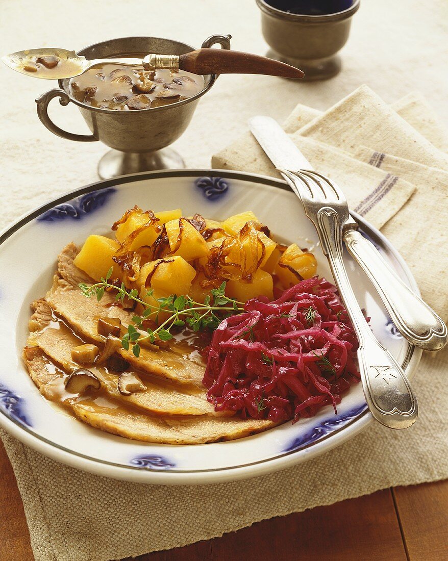 Plate of Sliced Pork with Mushroom Gravy, Red Cabbage and Squash