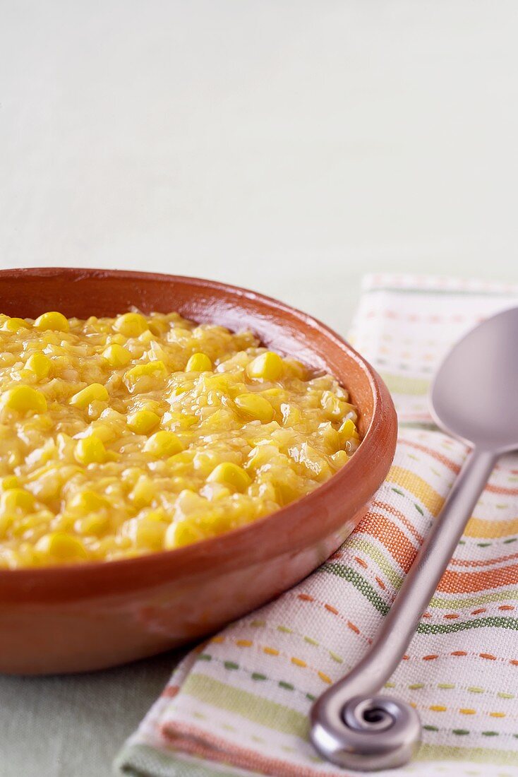 Bowl of Creamed Corn; Spoon on a Napkin