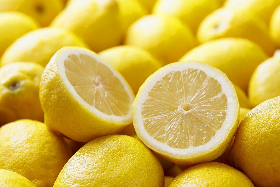Many Whole Fresh Lemons; One Halved