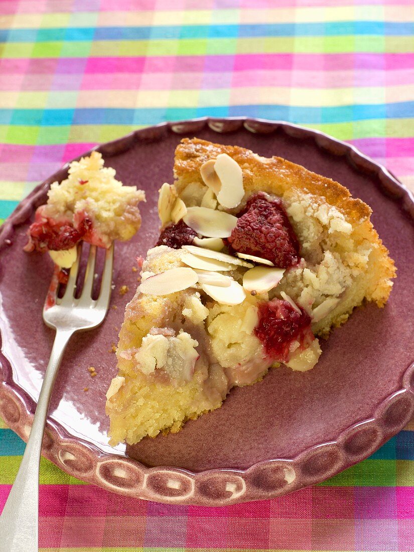 Slice of Raspberry Almond Cake on a Plate with a Fork