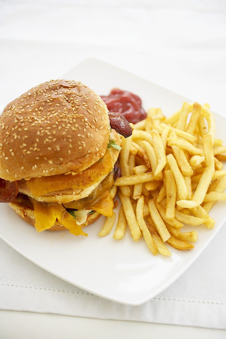 Barbecue Bacon Double Cheeseburger with Fries on a White Plate